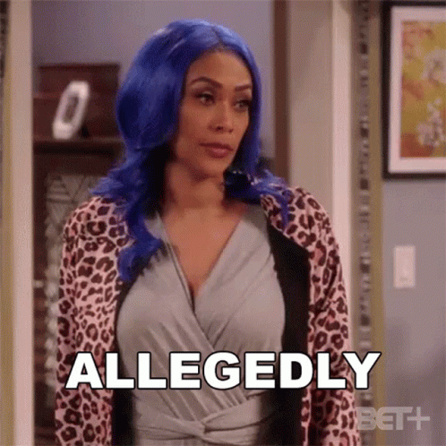 A Woman With Blue Hair And A Leopard Print Jacket Is Standing In A Hallway And Saying Allegedly . GIF