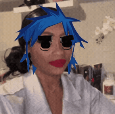 A Woman With Blue Hair And Black Eyes Has A Cartoon Face On Her Face GIF