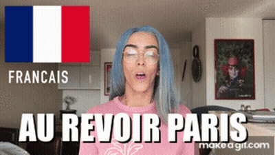 A Woman With Blue Hair And Glasses Is Wearing A Pink Sweater That Says Au Revoir Paris On It GIF