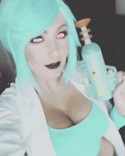 A Woman With Blue Hair And Pink Eyes Is Holding A Gun GIF