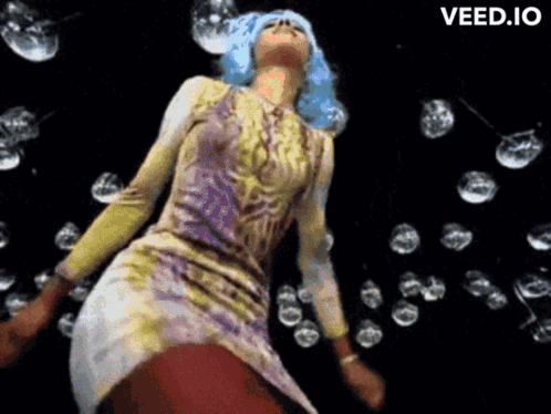 A Woman With Blue Hair Is Dancing In Front Of Bubbles And The Word Veed.io Is On The Bottom Right GIF