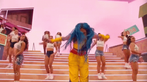 A Woman With Blue Hair Is Dancing With A Group Of Women On Stairs . GIF