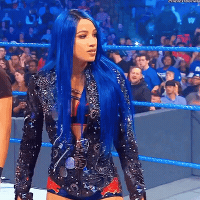 A Woman With Blue Hair Is In A Wrestling Ring GIF