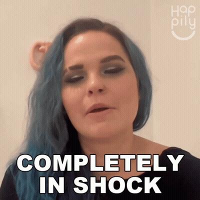 A Woman With Blue Hair Is Making A Face And Says Completely In Shock GIF