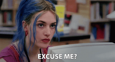 A Woman With Blue Hair Is Sitting In Front Of A Computer And Says Excuse Me ? GIF