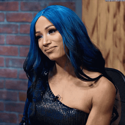 A Woman With Blue Hair Is Wearing A Black Top GIF