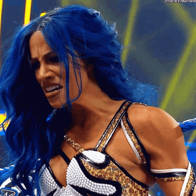 A Woman With Blue Hair Is Wearing A Leopard Print Top GIF