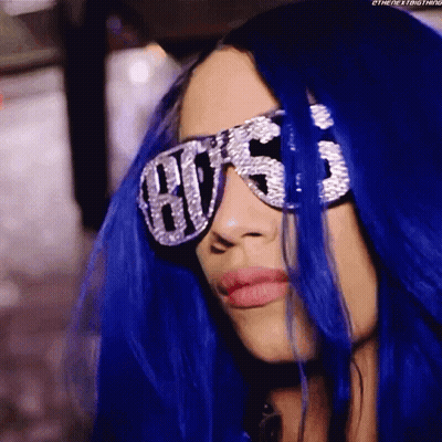 A Woman With Blue Hair Is Wearing A Pair Of Sunglasses With The Word Hustle On Them GIF