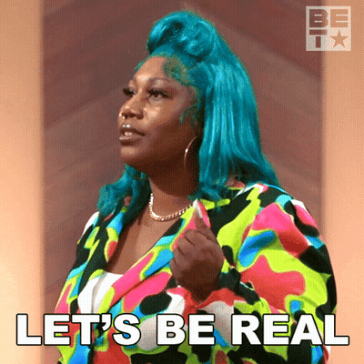 A Woman With Blue Hair Says Let 'S Be Real While Holding A Piece Of Paper GIF