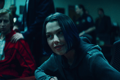 A Woman With Blue Hair Sits At A Table With A Man In A Red Jacket GIF