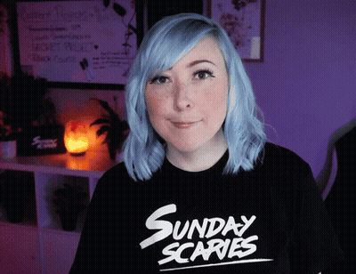 A Woman With Blue Hair Wears A Sunday Scaries Shirt GIF