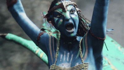 A Woman With Blue Paint On Her Body Is Screaming With Her Arms In The Air GIF
