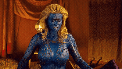 A Woman With Blue Paint On Her Body Is Standing In A Room With Her Arms Outstretched GIF