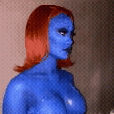 A Woman With Blue Paint On Her Face And Body GIF