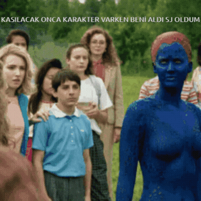 A Woman With Blue Paint On Her Face Is Standing In Front Of A Group Of People In A Field GIF