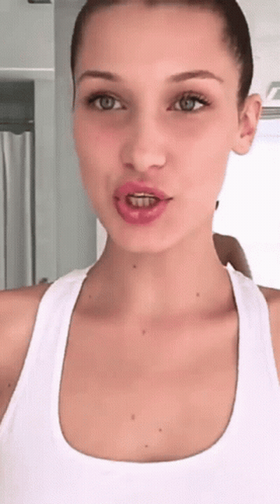 A Woman With Braces On Her Teeth Is Taking A Selfie GIF