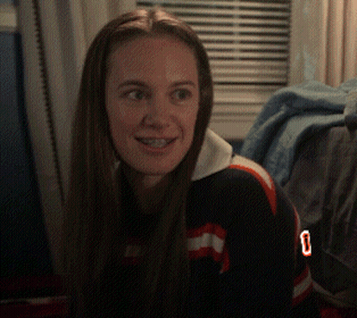 A Woman With Braces On Her Teeth Is Wearing A Jersey With The Number 0 On It GIF