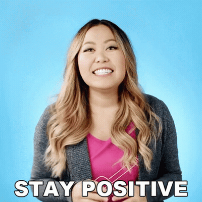 A Woman With Braces On Her Teeth Smiles And Says Stay Positive GIF