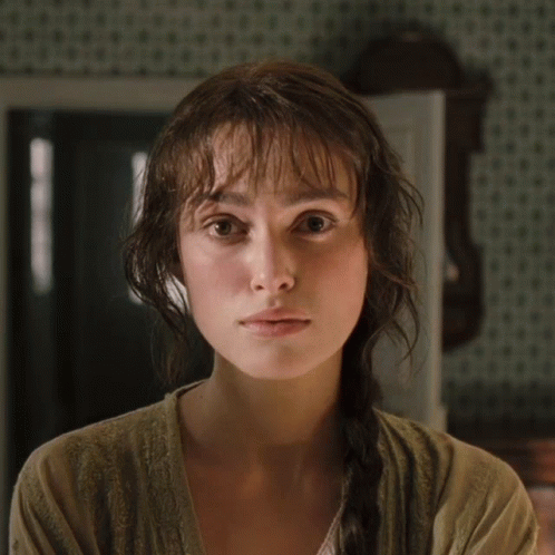 A Woman With Braided Hair Looks At The Camera GIF