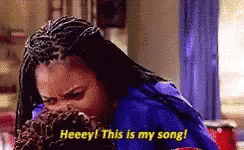 A Woman With Braids Is Covering Her Mouth With Her Hand And Saying , `` Heeey ! This Is My Song ! '' GIF