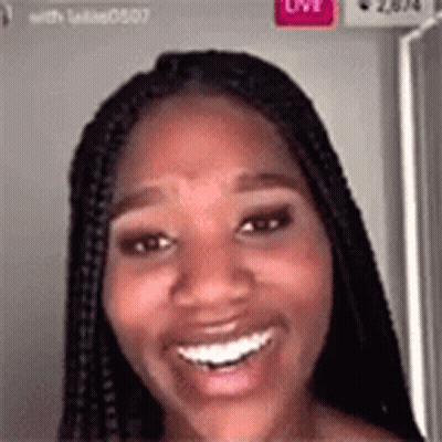 A Woman With Braids Is Smiling And Looking At The Camera In A Video Call . GIF