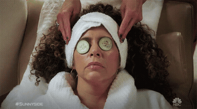 A Woman With Cucumber Slices On Her Eyes Is Getting A Massage From Sunnyside GIF