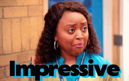 A Woman With Curly Hair And A Lanyard That Says Impressive On It GIF