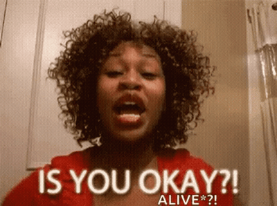 A Woman With Curly Hair Is Asking Is You Okay ? Alive * ? . GIF