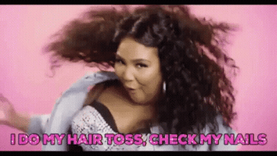 A Woman With Curly Hair Is Dancing On A Pink Background . GIF