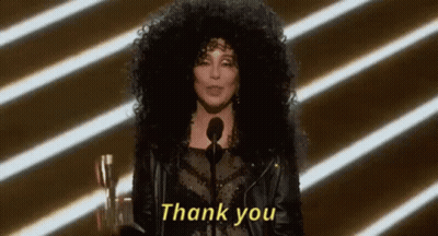 A Woman With Curly Hair Is Giving A Speech And Says Thank You . GIF