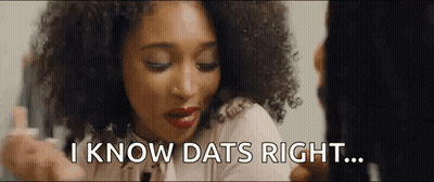A Woman With Curly Hair Is Looking At Herself In The Mirror And Saying `` I Know Dats Right '' . GIF