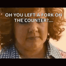 A Woman With Curly Hair Is Looking At The Camera And Says `` Oh You Left A Fork On The Counter ? '' GIF