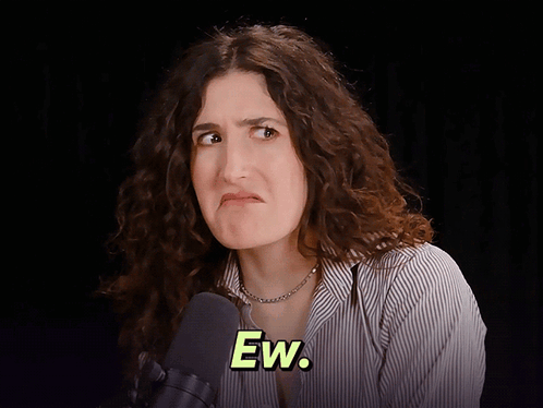 A Woman With Curly Hair Is Making A Face And The Word Ew Is On The Bottom Right GIF