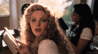 A Woman With Curly Hair Is Reading A Book And The Words Timelordwho Are Visible In The Corner GIF