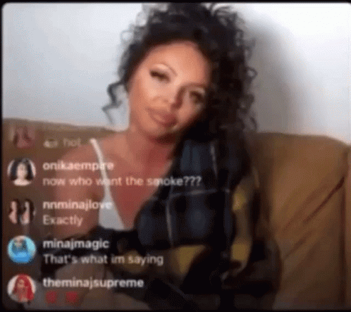 A Woman With Curly Hair Is Sitting On A Couch And Talking To A Group Of People On A Live Stream . GIF
