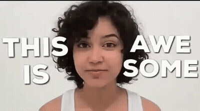 A Woman With Curly Hair Is Standing In Front Of A White Background With The Words `` This Awe Is Some '' . GIF