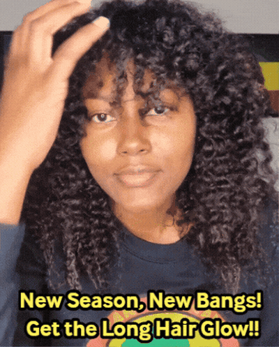 A Woman With Curly Hair Is Wearing A Blue Shirt That Says New Season New Bangs Get The Long Hair Glow !! GIF
