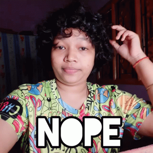 A Woman With Curly Hair Is Wearing A Shirt That Says Nope On It GIF