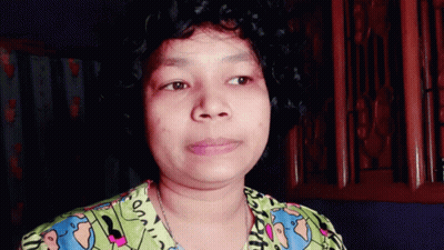 A Woman With Curly Hair Is Wearing A Shirt That Says ' On ' On The Front GIF