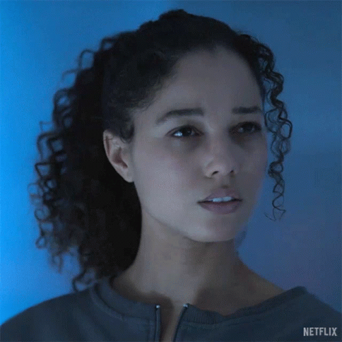 A Woman With Curly Hair Says Come Again On A Netflix Ad GIF