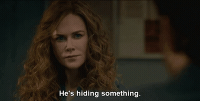 A Woman With Curly Hair Says He 'S Hiding Something In Front Of A Man GIF