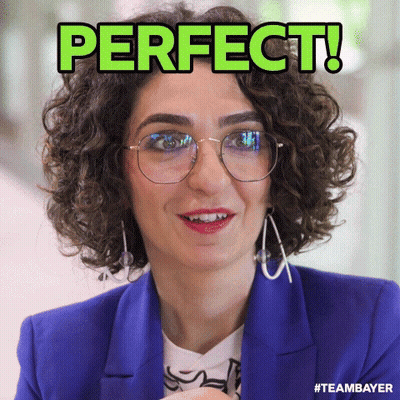 A Woman With Curly Hair Wearing Glasses And A Blue Jacket Has The Word Perfect Written On Her Face GIF