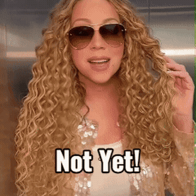 A Woman With Curly Hair Wearing Sunglasses And A Caption That Says Not Yet GIF