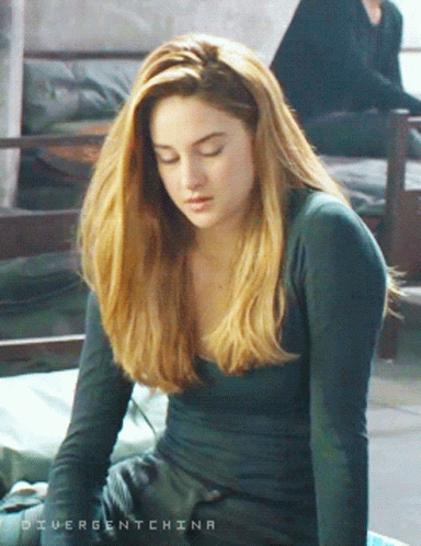 A Woman With Divergent China Written On The Bottom GIF