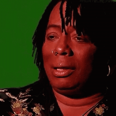 A Woman With Dreadlocks And A Nose Ring Is Crying . GIF