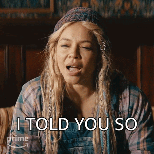 A Woman With Dreadlocks And A Plaid Shirt Is Saying I Told You So GIF