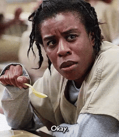 A Woman With Dreadlocks Is Holding A Spoon And Says Okay . GIF