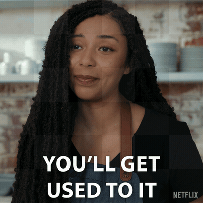 A Woman With Dreadlocks Says " You 'Ll Get Used To It " In White Letters GIF