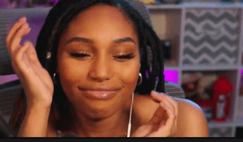 A Woman With Dreadlocks Wearing Headphones And A Smile On Her Face GIF