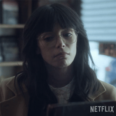 A Woman With Glasses And A Netflix Logo In The Background GIF